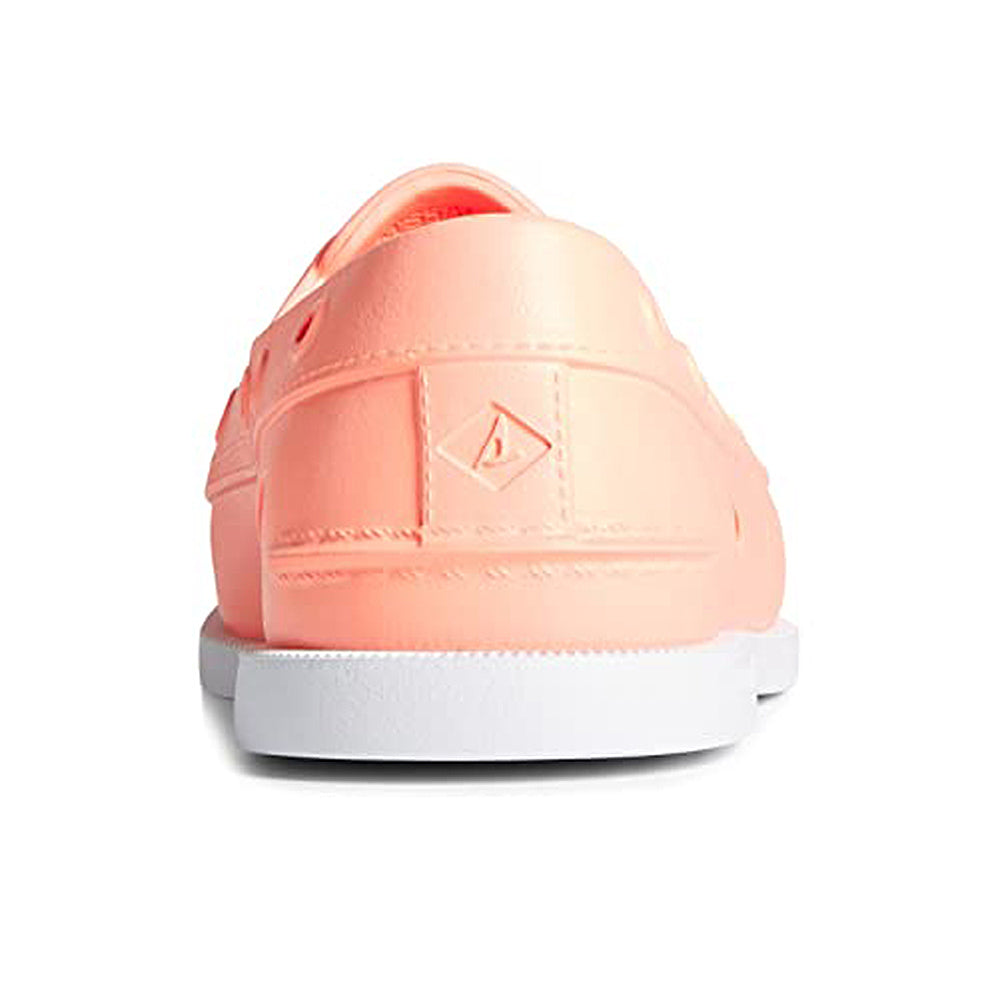 Rear view of the Sperry Authentic Original Float Boat sneaker for women in light coral pink with a white wave-siping sole and embossed heel logo. Set against a white background.