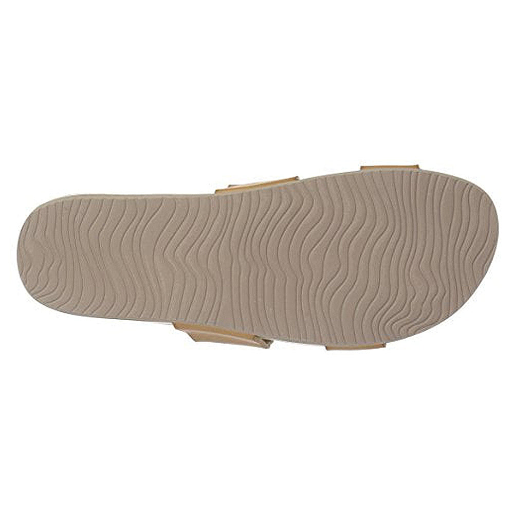 The Reef Cushion Vista - Womens sandals in beige feature a textured sole with wavy, ripple-like patterns for enhanced traction, as seen from the bottom.