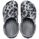 The Crocs Classic Camo Clog - Unisex features a black and white camouflage pattern, ventilation holes, adjustable heel straps, and offers comfortable slip-on water shoe convenience.