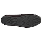 The image shows the bottom view of a black TOMS Alpargata - Womens shoe, featuring a textured rubber sole with zigzag and diamond patterns and the TOMS name embossed in the center.