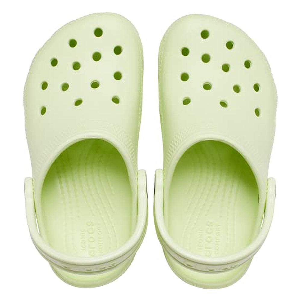 A pair of light green Crocs Classic Clog - Kids with top ventilation holes and adjustable heel straps, shown from above on a white background.