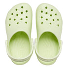 A pair of light green Crocs Classic Clog - Kids with top ventilation holes and adjustable heel straps, shown from above on a white background.