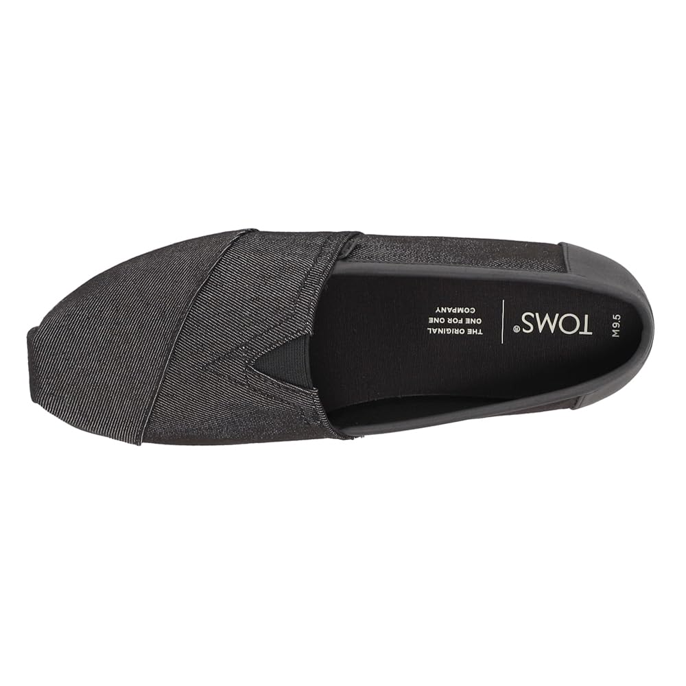 Top view of a single black Classic Canvas - Men alpargata by TOMS, with a rounded toe, diagonal stitching, classic slip-on design, and TOMS branding on the insole.