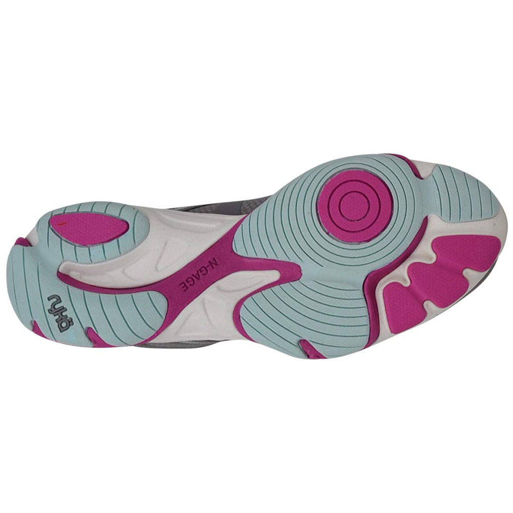 The image shows the sole of the Ryka Influence - Women workout shoe in light blue, magenta, and white. Circular and geometric tread patterns cover the sole, with MCARGE visible near the arch.
