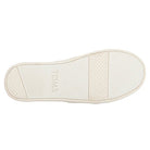 The image shows the white rubber sole of the TOMS Alpargata ESP - Women slip-on, featuring TOMS at the center. The tread has textured grips at the toe and heel, with a smoother middle section.