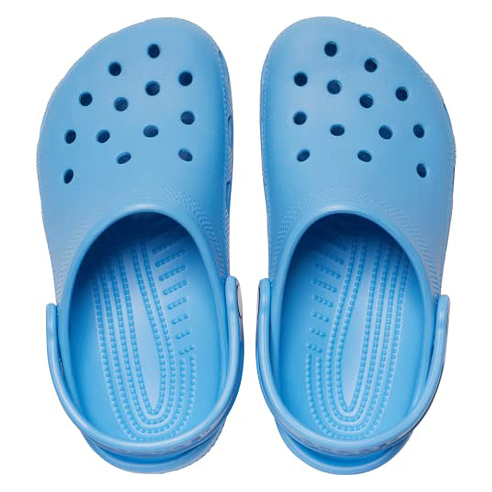 A pair of Crocs Classic Clog - Kids in light blue, featuring perforated holes on top and adjustable heel straps, viewed from above.