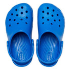 A pair of bright blue Crocs Classic Clog - Kids, featuring ventilation holes and a back strap, viewed from above.