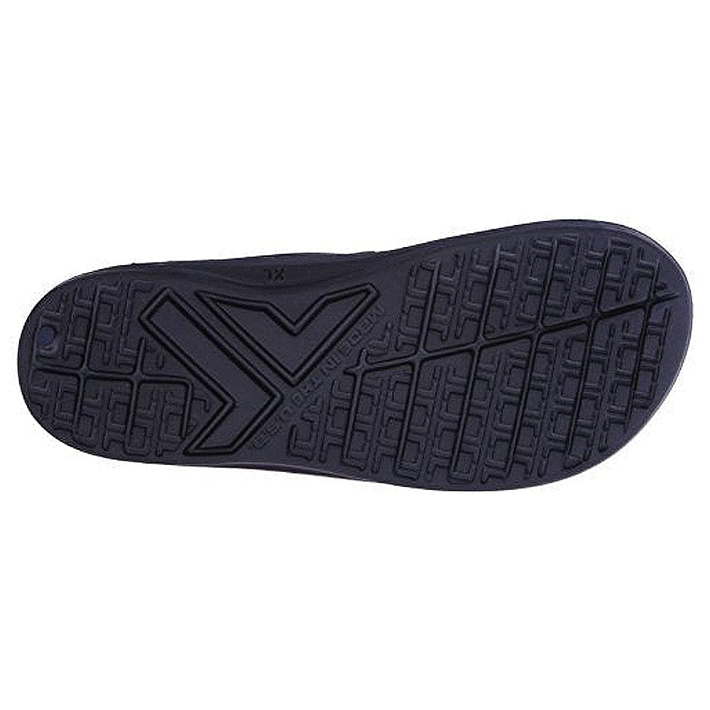 The black sole of the Telic Footwear Energy Flip Flop - Unisex features a geometric tread with lines for grip, a bold central arrow-like design, and raised text, providing both style and function when viewed from below.