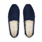 A top view of TOMS Alpargata - Womens shoes in navy blue, made with recycled cotton canvas and featuring branded, light-colored insoles with perforations for breathability.
