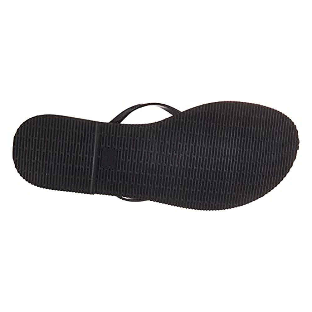 The image shows the bottom view of a black Havaianas Slim Metalic - Womens sandal with a textured rubber sole and a visible thin strap on one side.