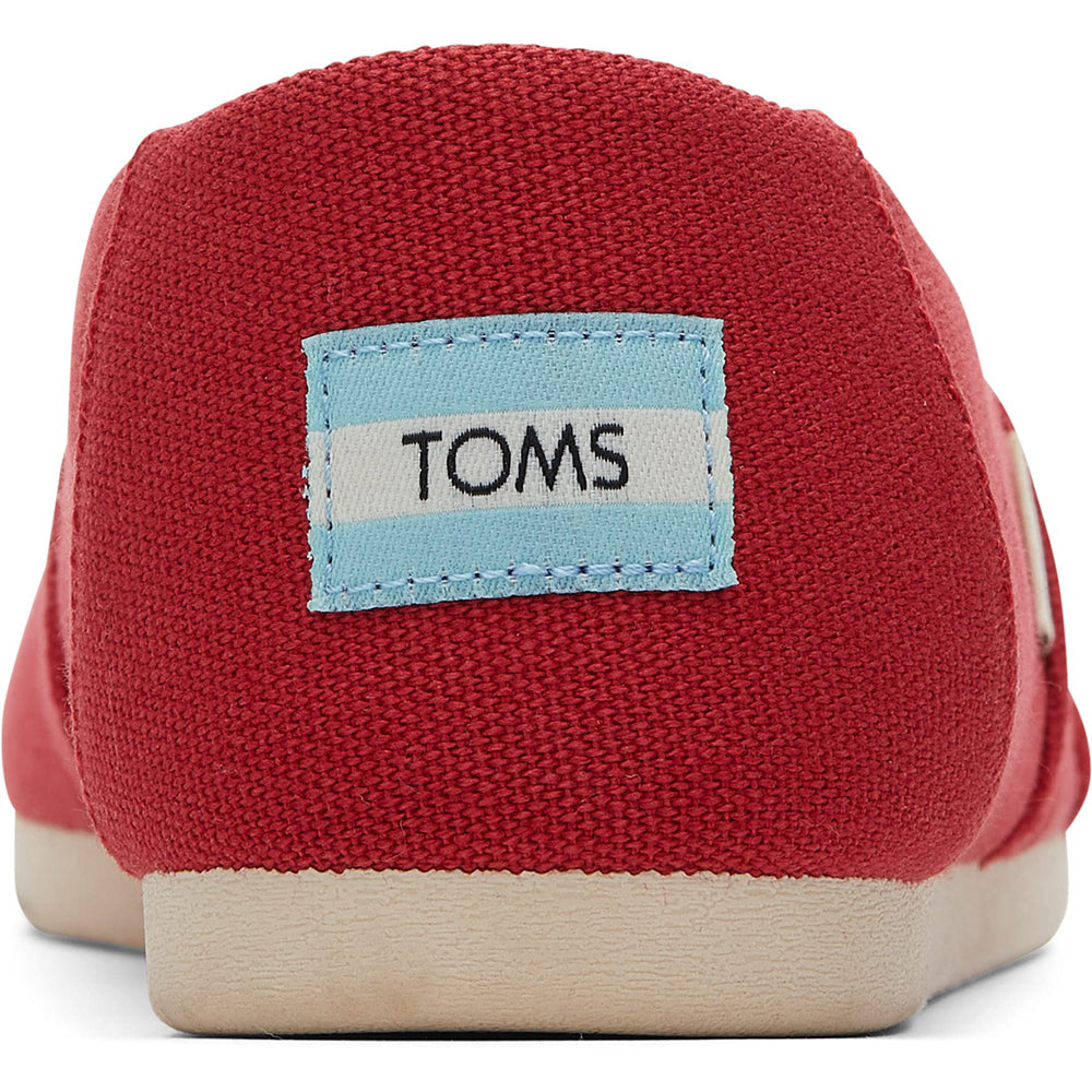 Close-up of the back of a red TOMS Alpargata - Womens shoe featuring a light blue and white TOMS logo patch on the heel and a light-colored sole, made from recycled cotton.