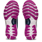 The ASICS Gel Nimbus 23 - Womens shoes are shown from the bottom, highlighting their purple and white textured soles with wavy tread patterns for traction and shock absorption.
