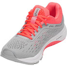 The ASICS GT-1000 7 - Womens features a gray and coral pink mesh upper, coral laces, white cushioned sole with DUOMAX support, and ASICS logo on the side—designed for road stability running.