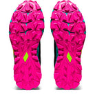 Two ASICS GEL-FujiTrabuco 8 - Womens trail running shoes are pictured from below, showing bright pink rugged soles with deep treads, yellow accents near the arch, and an angular tread pattern engineered for traction.