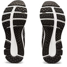 A pair of black and white ASICS GEL-PULSE 12 - Womenss running shoes are shown from the bottom, featuring textured rubber soles with patterned treads for traction and an AmpliFoam midsole for comfort.