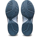 The ASICS Gel Dedicate 7 - Mens tennis shoes in blue and white are shown from below, displaying their textured rubber outsoles with geometric grooves designed to boost traction and stability on the court.