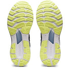 The image shows the yellow, white, and gray patterned outsoles of ASICS Gel Kayano 28 - Mens stability running shoes. The bottom view displays multi-grooved, textured tread for grip and advanced GEL technology.