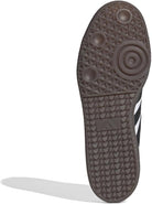 The image displays the black rubber sole of the adidas Samba OG - Men shoe, highlighting textured circular tread patterns. The iconic adidas logo appears at the center, combining street style with classic design.