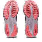 The image displays the ASICS Gel Nimbus 25 - Womens running shoes, which have light gray soles accented with coral pink grip sections and perforated patterns for traction and lightweight cushioning.