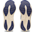 The ASICS Gel Nimbus 25 - Womens shoes are shown side by side, with beige soles, navy blue textured rubber grips, and multiple ventilation holes on the bottom to highlight their lightweight cushioning.
