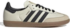 The adidas Samba OG - Women features a white leather upper, black stripes, beige suede toe cap, black laces, and a light brown rubber sole—an iconic classic from adidas.