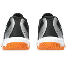 Rear view of ASICS Gel-Rocket 11 Womens indoor court shoes, featuring black uppers, silver accents, white midsoles, and orange textured outsoles—built for maximum on-court stability and shown side by side on a white background.