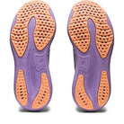 The image shows the soles of ASICS Gel Nimbus 25 - Womenss shoes, featuring primarily purple outsoles with orange textured grip zones and perforated patterns for enhanced traction, flexibility, and lightweight cushioning—ideal for running.