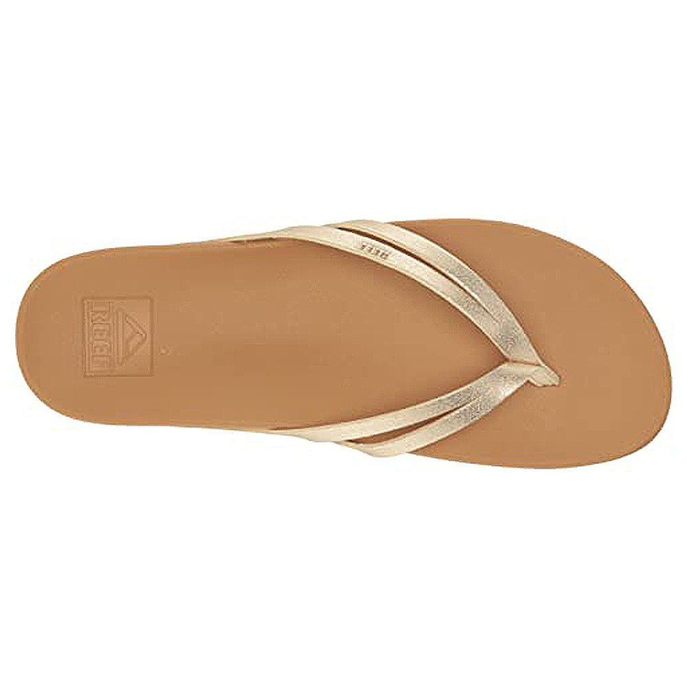 A top view of the Reef Cushion Spring Joy - Womens sandal in tan with metallic gold straps, featuring a cushioned footbed and minimalist design, ideal for womens flip flops.