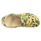 A top view of the Crocs Classic Camo Clog - Unisex, showcasing its beige, green, and yellow camouflage pattern with ventilation holes on the upper.