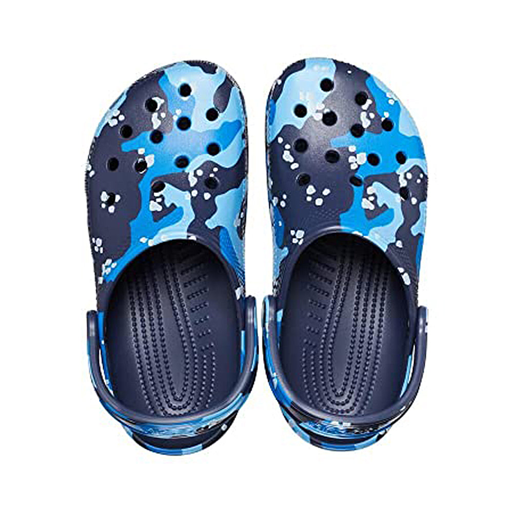 The Crocs Classic Camo Clog - Unisex shoes, shown from above, display a blue and navy camo pattern with top ventilation holes and an adjustable heel strap.