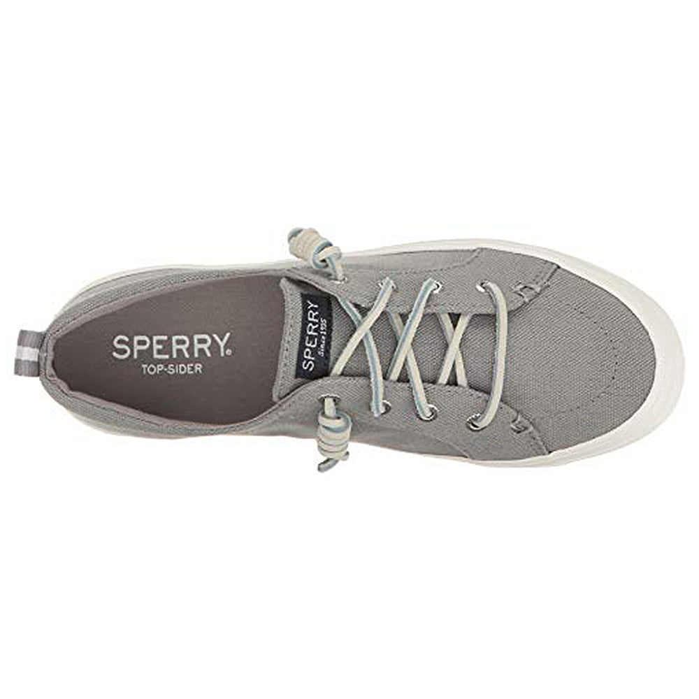 Top view of a gray Sperry Crest Vibe - Womens canvas sneaker with a white rubber sole, light gray laces, and heel pull tab. This durable shoe offers arch support, and the SPERRY logo is visible on the insole.