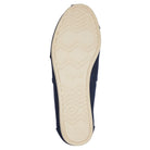 The Alpargata ESP - Women by TOMS features a navy blue slip-on design with a sole that has a light-colored rubber bottom, zigzag and diamond tread pattern, and the TOMS brand name embossed in the center.