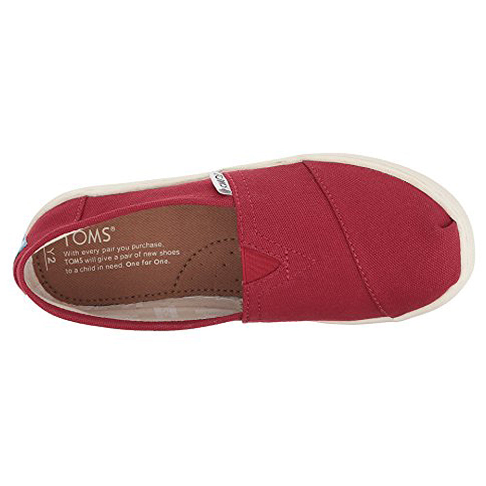 Top view of a single red TOMS Alpargata ESP slip-on for women with a tan rubber sole. The insole reads TOMS, reflecting their buy one, give one charitable shoe donation program.