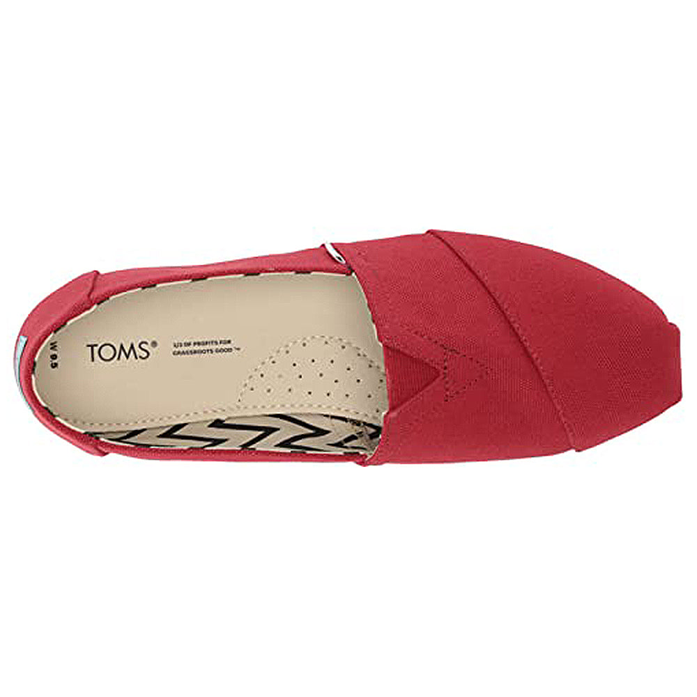 Top view of a red Alpargata - Womens canvas slip-on by TOMS with a beige insole labeled TOMS and a chevron pattern near the heel. Part of the earthwise collection, crafted with recycled cotton for eco-friendly comfort.