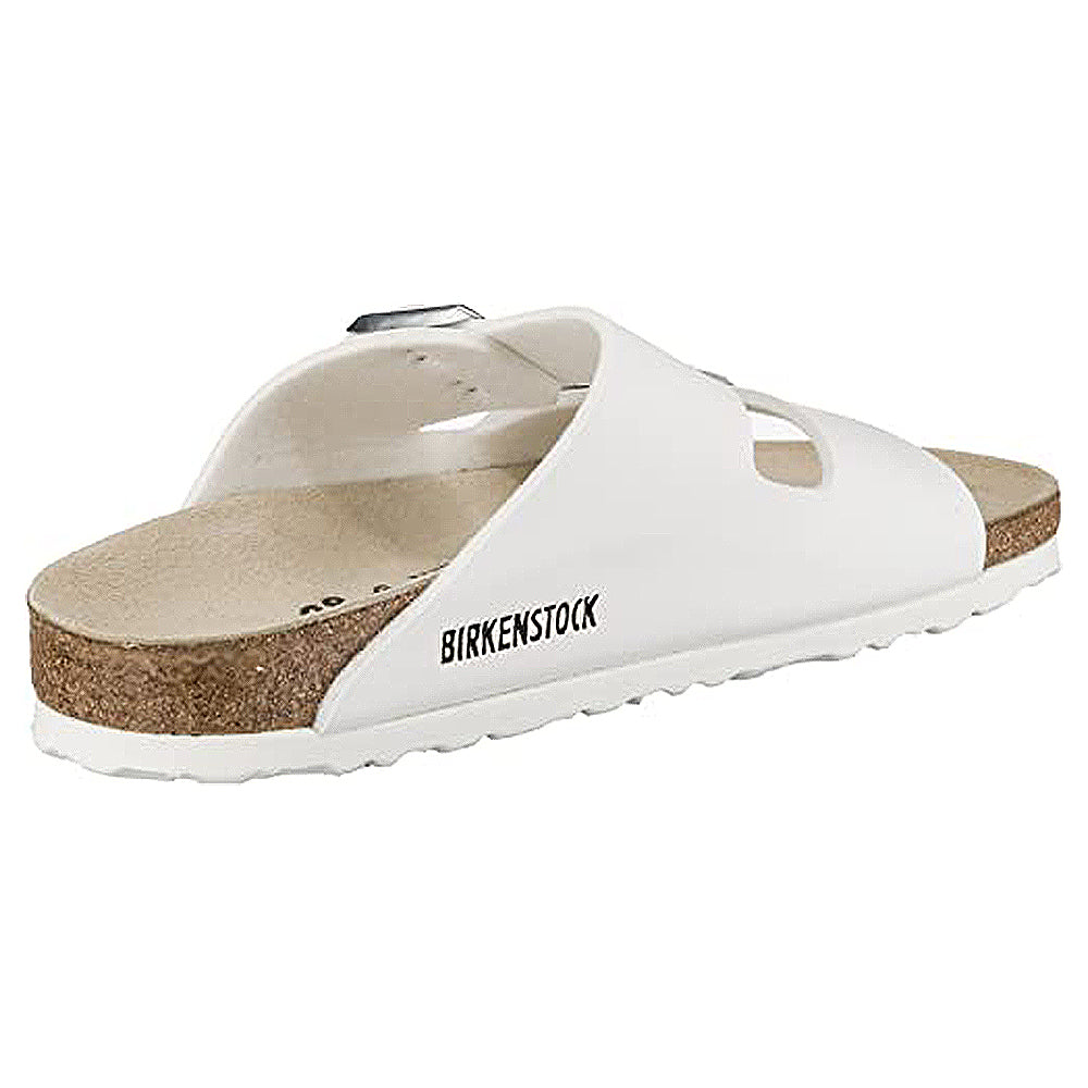 The Birkenstock Arizona – Womens is a white double-strap sandal with a cork footbed, a white sole, and an open-toe design for orthopedic comfort, shown from the side and slightly behind.
