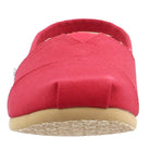 Front view of the TOMS Classic Canvas - Men slip-on in red, featuring a beige rubber sole and visible stitching, inspired by the iconic TOMS design.