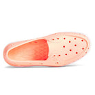 Top-down view of the Sperry Authentic Original Float Boat - Women, a light pink slip-on with ventilation holes, drainage gills, wave-siping traction on the white-accented sole, textured insole, and embossed Sperry branding inside.