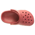 A top view of a single pink Crocs Classic Clog - Kids shoe, featuring ventilation holes on the toe and an adjustable heel strap.