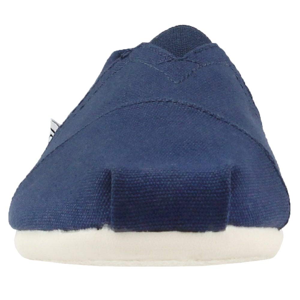 A close-up front view of the TOMS Classic Canvas - Men alpargata in navy blue, featuring a slip-on design and white rubber sole, photographed against a white background.