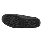 The image displays the black rubber sole of a TOMS Classic Canvas - Men shoe, featuring geometric tread patterns and the TOMS logo imprinted near the center.