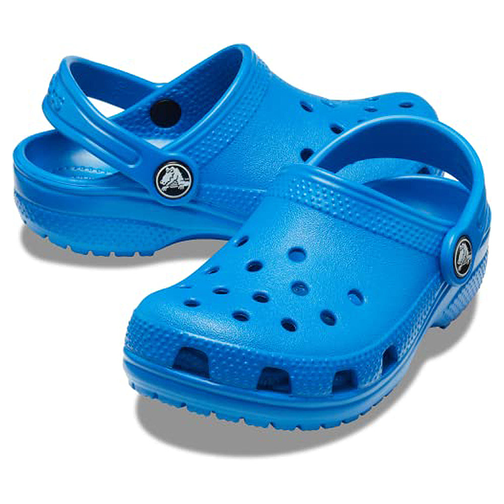 A pair of Crocs Classic Clog - Kids in bright blue, featuring ventilation holes and a heel strap, displayed on a white background.