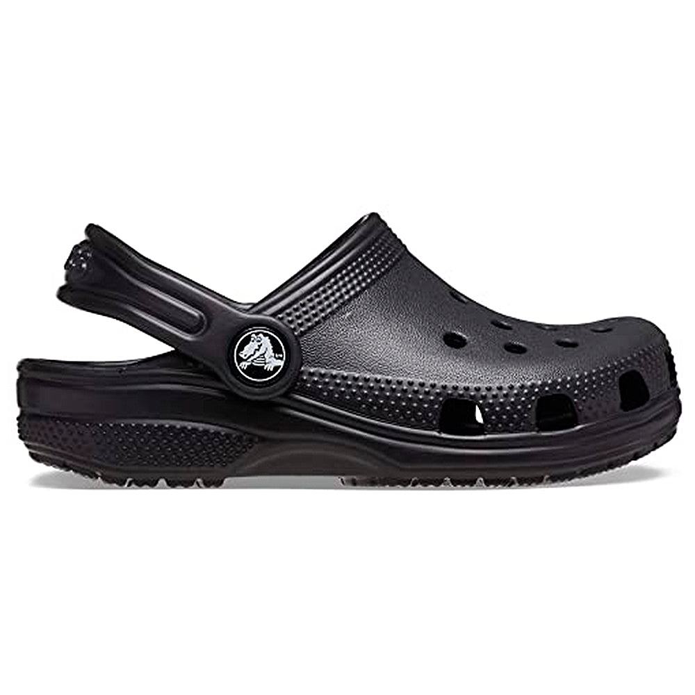 The Crocs Classic Clog - Kids, shown in black with ventilation holes and an adjustable back strap, is displayed from the side against a white background.