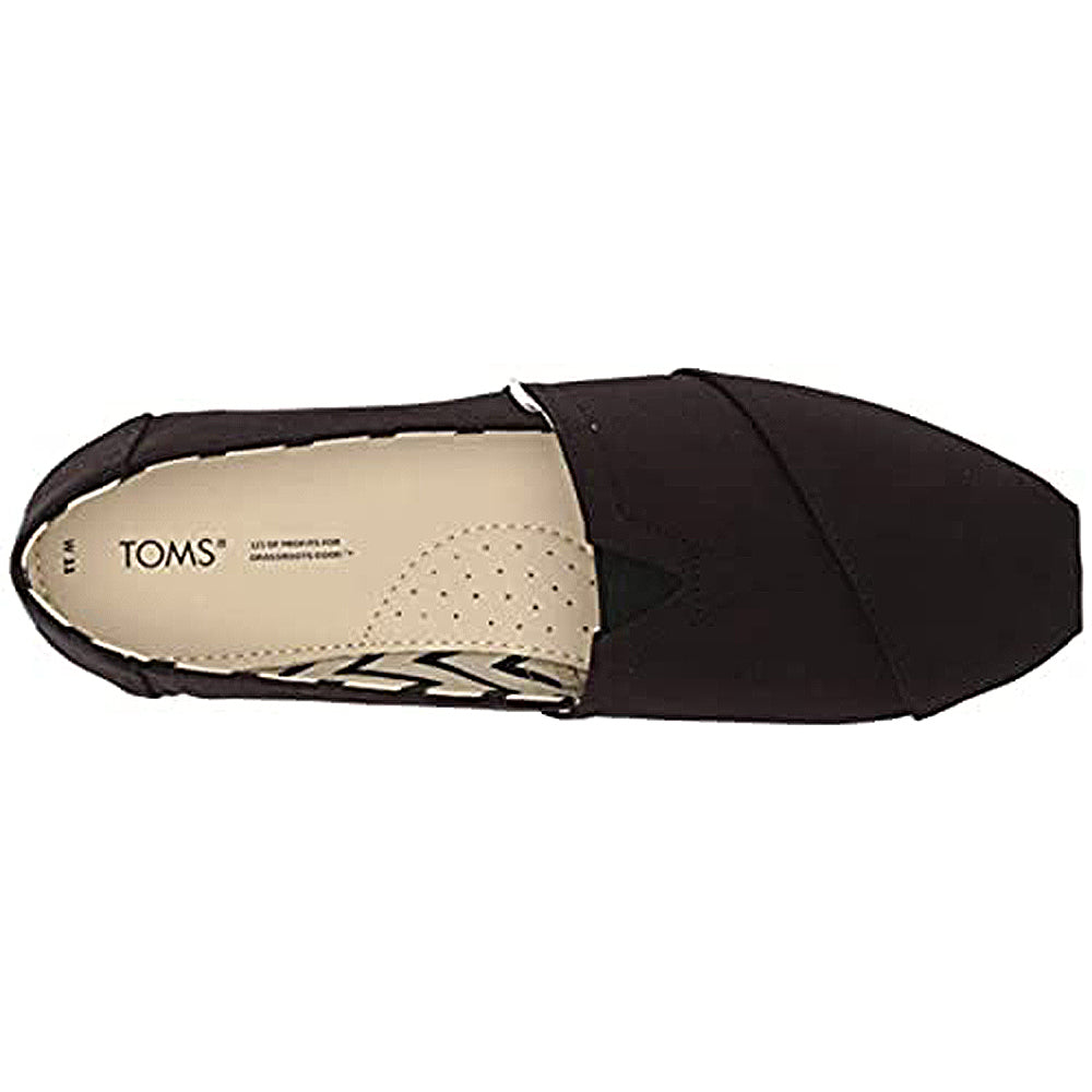 Top view of the TOMS Alpargata - Womens slip-on in black, featuring a rounded toe, stitched recycled cotton upper, and a beige insole with the TOMS logo and perforations for breathability.