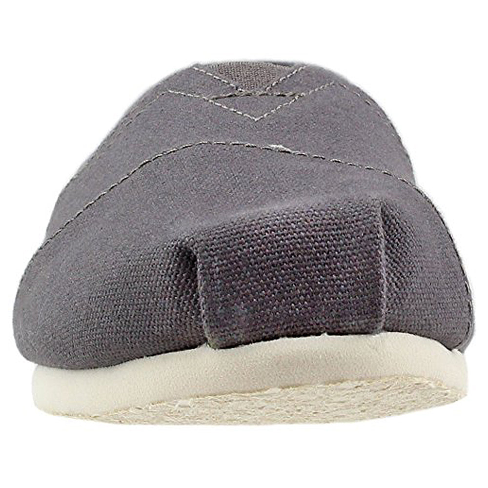 A front view of the TOMS Alpargata ESP slip-on for women in gray canvas with visible stitching and a white rubber sole, highlighting the brands iconic design and their buy-one-give-one commitment.
