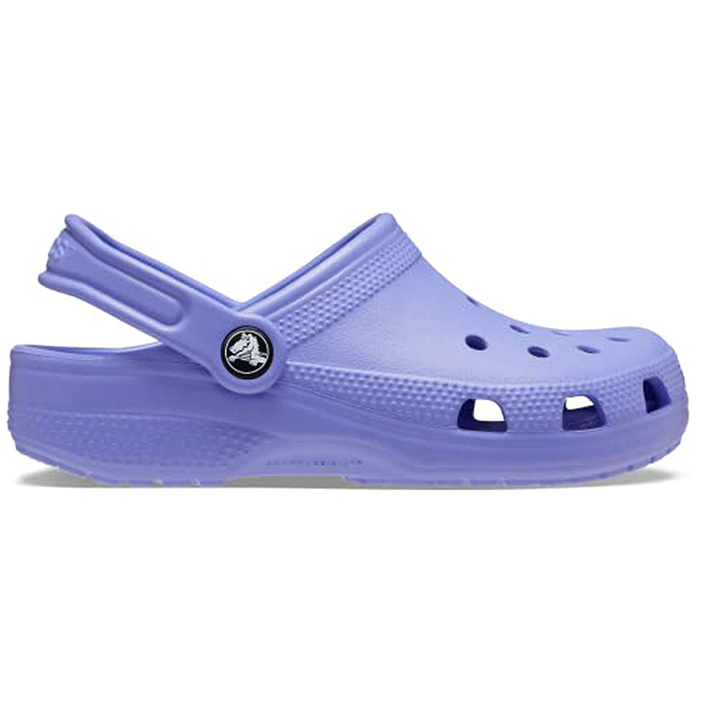The Classic Clog - Kids by Crocs is a lavender clog featuring a back strap, ventilation holes on the top and sides, and a black circular Crocs logo near the heel.