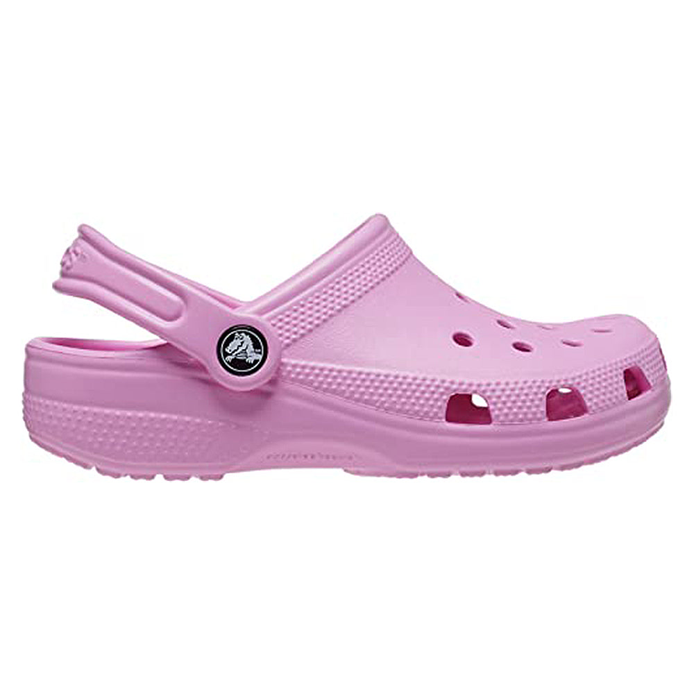 A single Crocs Classic Clog - Kids in pink with ventilation holes and an adjustable heel strap is shown from the side on a white background—ideal everyday comfort footwear for kids.