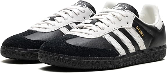 The adidas Samba OG - Men features a black leather upper, white stripes, white laces, gold Samba text, and a black sole. This classic low-top sneaker is perfect for street style.