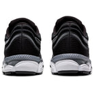 A pair of black ASICS Gel-Ziruss 3 - Mens running shoes seen from the back, highlighting the textured heel, white and gray midsoles, and reflective accents.