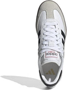 Top view of the adidas Samba OG - Men sneaker in white leather with black stripes, gray suede toe cap, and white laces. The tongue label features the adidas logo and SAMBA text in red, enhancing its classic street style appeal.