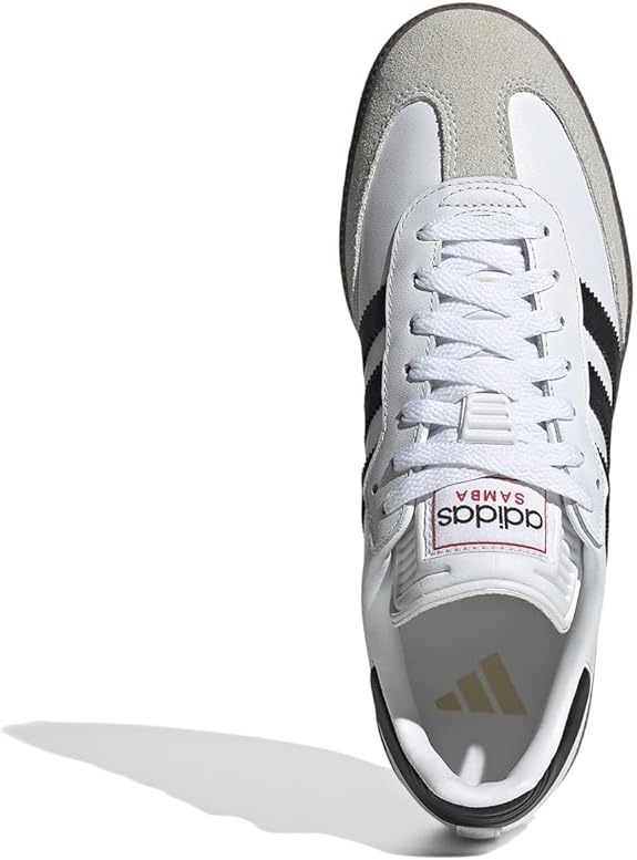 Top view of the adidas Samba OG - Men sneaker in white leather with black stripes, gray suede toe cap, and white laces. The tongue label features the adidas logo and SAMBA text in red, enhancing its classic street style appeal.